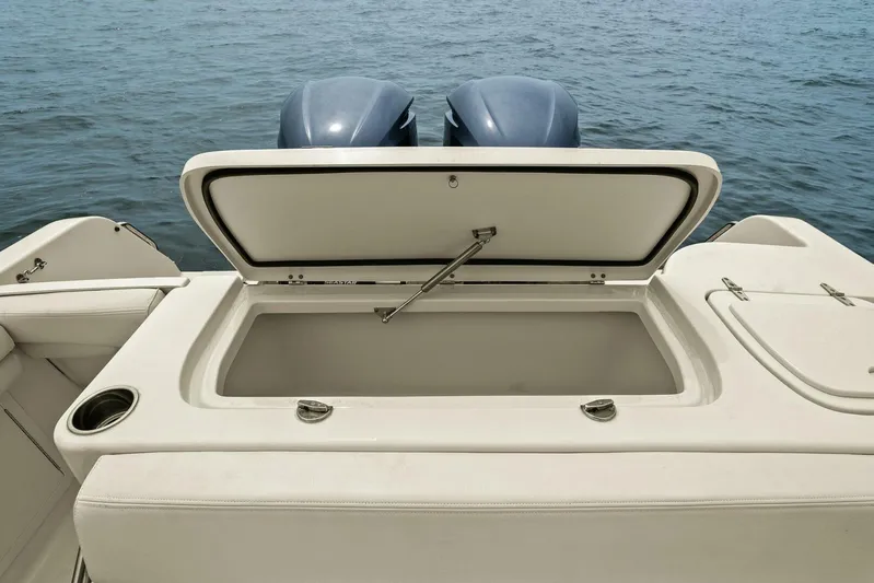 Patsy Ru Yacht Photos Pics 2016 Grady-White 285 Freedom boat with open storage compartment, dual engines, on calm water.