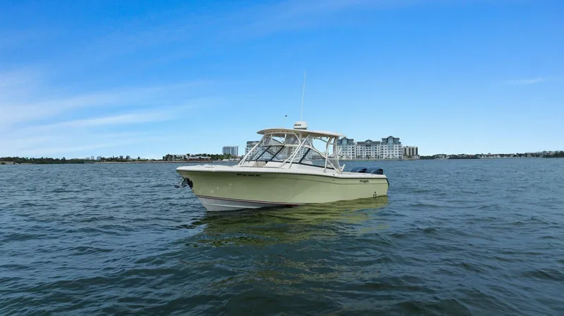 Patsy Ru Yacht Photos Pics 2016 Grady-White 285 Freedom boat on open water with cityscape background.