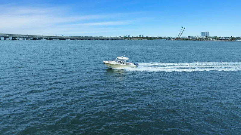 Patsy Ru Yacht Photos Pics 2016 Grady-White 285 Freedom boat cruising on open water under clear blue sky.