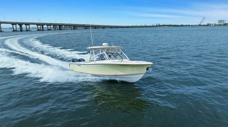 Patsy Ru Yacht Photos Pics 2016 Grady-White 285 Freedom boat cruising on open water near a bridge.