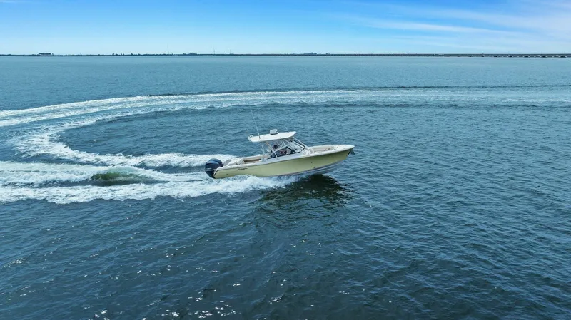 Patsy Ru Yacht Photos Pics 2016 Grady-White 285 Freedom boat cruising on open water, creating a circular wake.