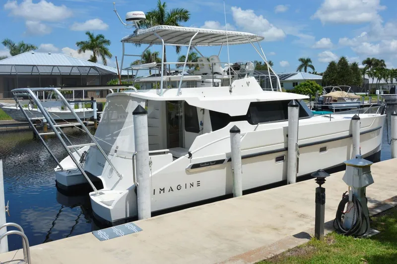 Imagine Yacht Photos Pics 2000 Fountaine Pajot Maryland 37 yacht docked in a sunny marina setting.
