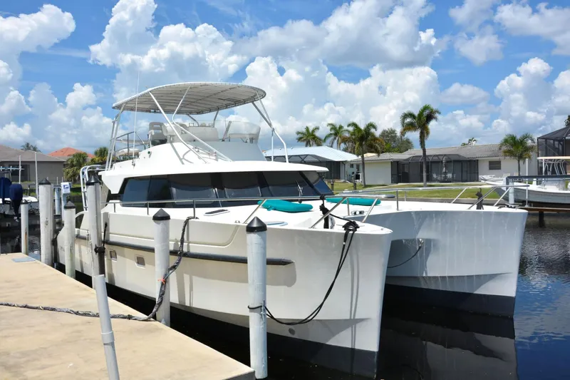 Imagine Yacht Photos Pics 2000 Fountaine Pajot Maryland 37 catamaran docked under a sunny sky.