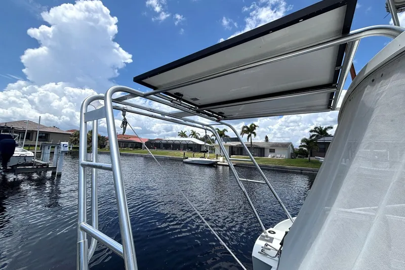 Imagine Yacht Photos Pics Fountaine Pajot Maryland 37 boat with solar panel, docked by waterfront homes, 2000 model.