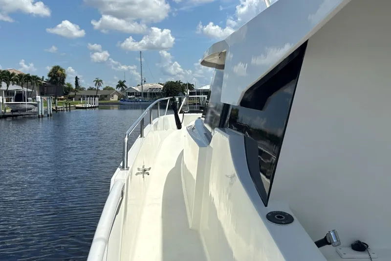 Imagine Yacht Photos Pics Fountaine Pajot Maryland 37 yacht, 2000 model, docked by a serene waterfront.