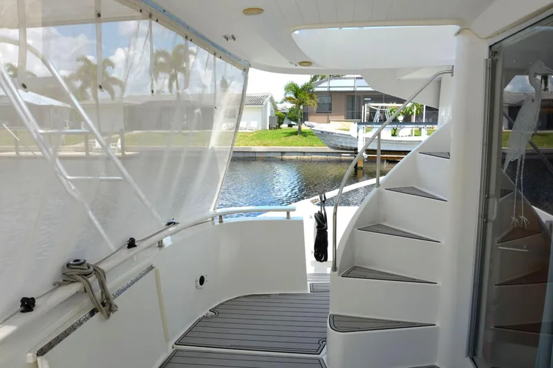 Imagine Yacht Photos Pics 2000 Fountaine Pajot Maryland 37 yacht interior with spiral staircase and waterfront view.