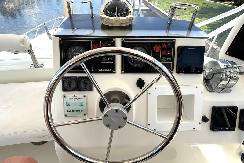 Imagine Yacht Photos Pics Helm of 2000 Fountaine Pajot Maryland 37 with steering wheel and navigation instruments.