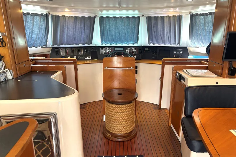 Imagine Yacht Photos Pics Interior of 2000 Fountaine Pajot Maryland 37 yacht with wooden finishes and navigation controls.