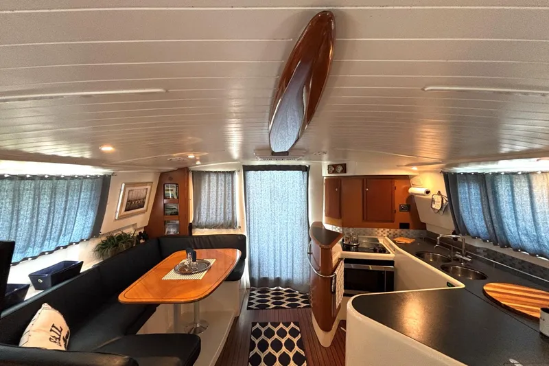 Imagine Yacht Photos Pics Interior of 2000 Fountaine Pajot Maryland 37 yacht with modern kitchen and dining area.
