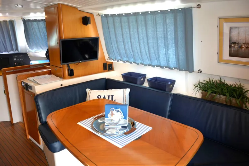 Imagine Yacht Photos Pics Interior of 2000 Fountaine Pajot Maryland 37 yacht with dining area and decor.