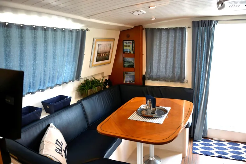 Imagine Yacht Photos Pics Interior of 2000 Fountaine Pajot Maryland 37 yacht with cozy seating and dining area.