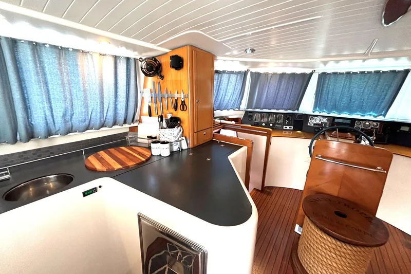 Imagine Yacht Photos Pics Interior of 2000 Fountaine Pajot Maryland 37 yacht with kitchen and helm station.