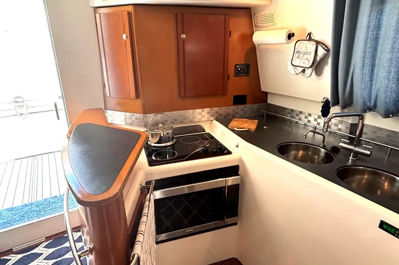Imagine Yacht Photos Pics Interior of 2000 Fountaine Pajot Maryland 37 yacht kitchen with stove, sink, and cabinets.