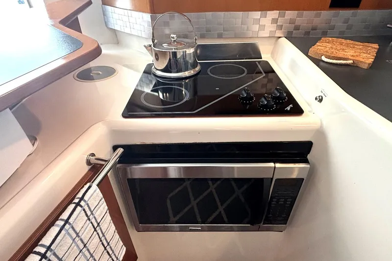 Imagine Yacht Photos Pics Galley kitchen in 2000 Fountaine Pajot Maryland 37 with stove and microwave.