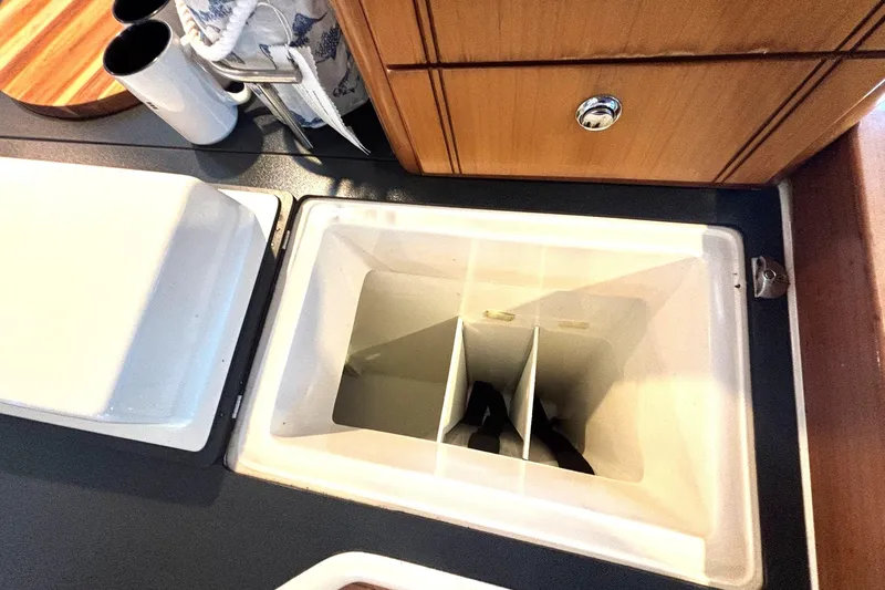 Imagine Yacht Photos Pics Open storage compartment in 2000 Fountaine Pajot Maryland 37 yacht kitchen area.