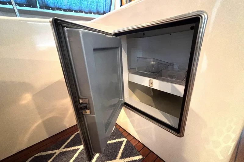 Imagine Yacht Photos Pics Open storage compartment on 2000 Fountaine Pajot Maryland 37 yacht, featuring interior shelving.