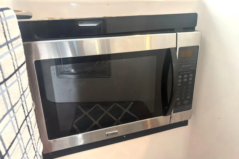 Imagine Yacht Photos Pics Built-in microwave on 2000 Fountaine Pajot Maryland 37 yacht, with stainless steel finish.