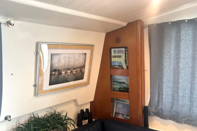 Imagine Yacht Photos Pics Interior of 2000 Fountaine Pajot Maryland 37 with framed art and nautical guides.