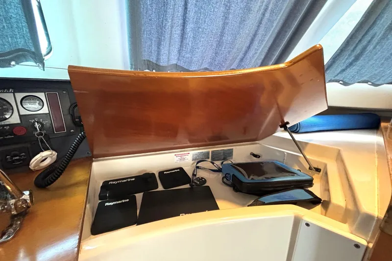 Imagine Yacht Photos Pics Control panel of 2000 Fountaine Pajot Maryland 37 with Raymarine equipment and wooden cover.