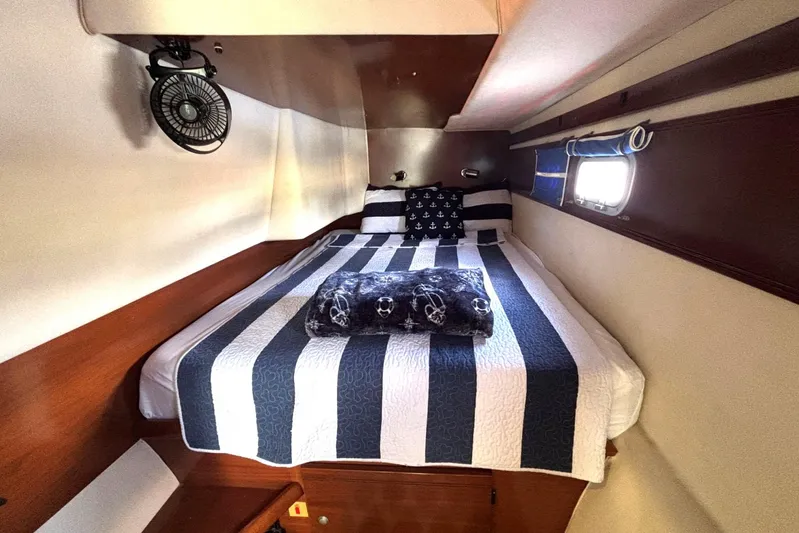 Imagine Yacht Photos Pics Cozy cabin interior of 2000 Fountaine Pajot Maryland 37 with striped bedding.