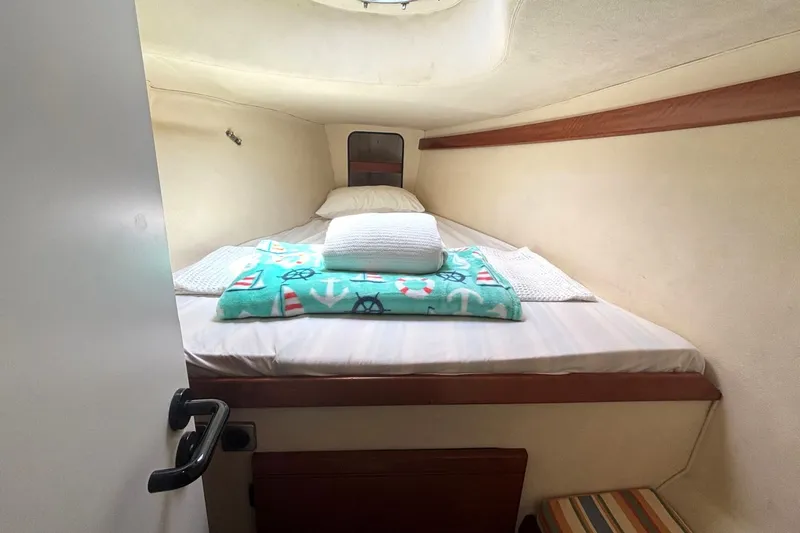 Imagine Yacht Photos Pics Cozy cabin interior of 2000 Fountaine Pajot Maryland 37 with nautical-themed bedding.