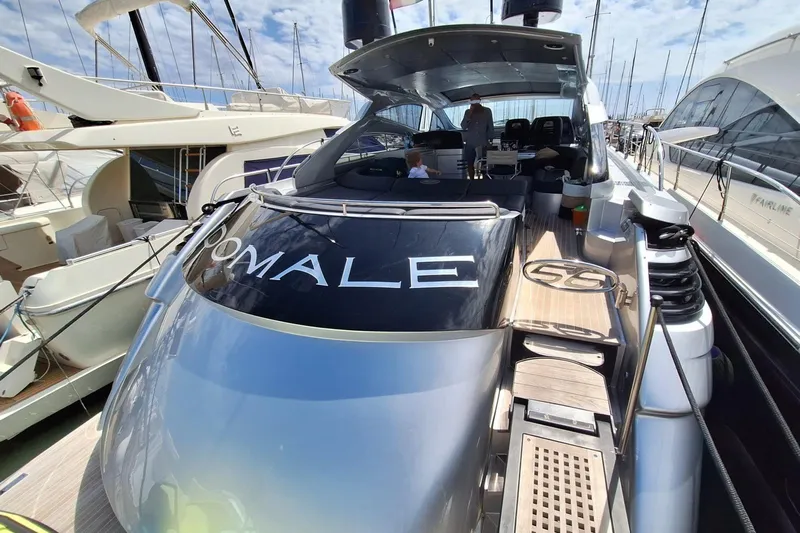 Domale Yacht Photos Pics 2009 Pershing 56 yacht docked at marina, featuring sleek design and spacious deck.