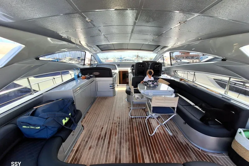 Domale Yacht Photos Pics Luxurious 2009 Pershing 56 yacht interior with seating, table, and modern design.