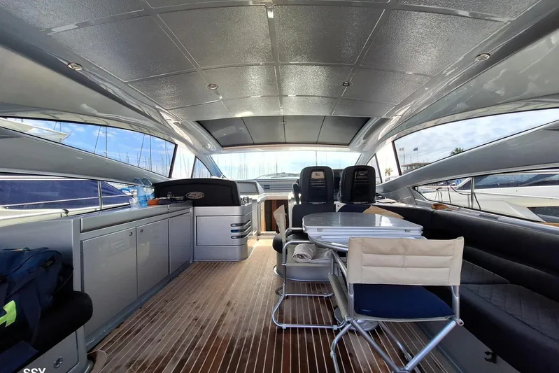 Domale Yacht Photos Pics Interior of a 2009 Pershing 56 yacht with sleek design and modern seating.