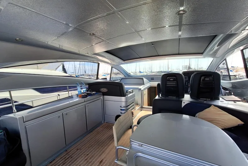 Domale Yacht Photos Pics Interior of a 2009 Pershing 56 yacht with modern seating and sleek design.