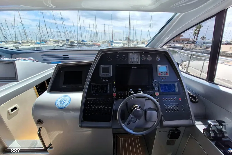 Domale Yacht Photos Pics Cockpit of 2009 Pershing 56 yacht with advanced navigation controls and marina view.