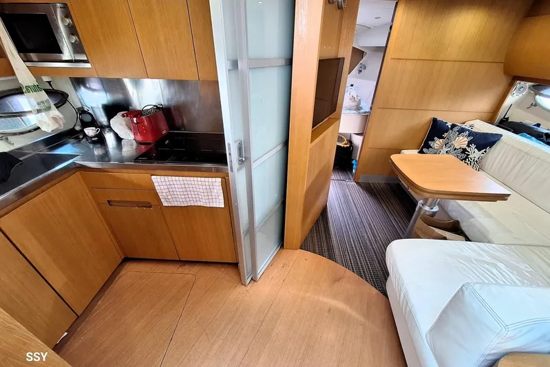 Domale Yacht Photos Pics Luxurious 2009 Pershing 56 yacht interior with modern kitchen and cozy seating area.