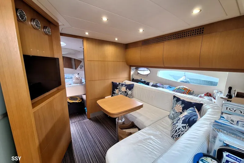 Domale Yacht Photos Pics Luxurious interior of a 2009 Pershing 56 yacht with cozy seating and modern decor.