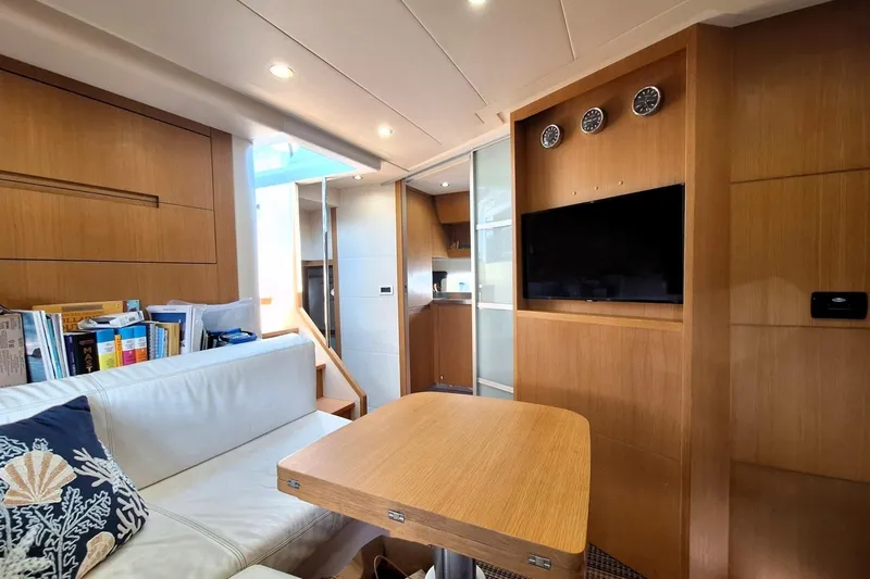 Domale Yacht Photos Pics Interior of 2009 Pershing 56 yacht with modern wood finish and cozy seating area.