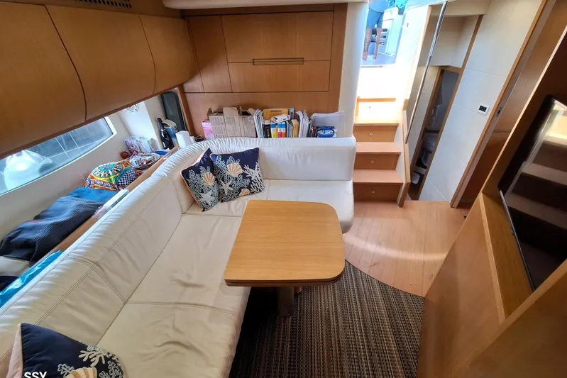 Domale Yacht Photos Pics Luxurious interior of a 2009 Pershing 56 yacht with cozy seating and elegant decor.