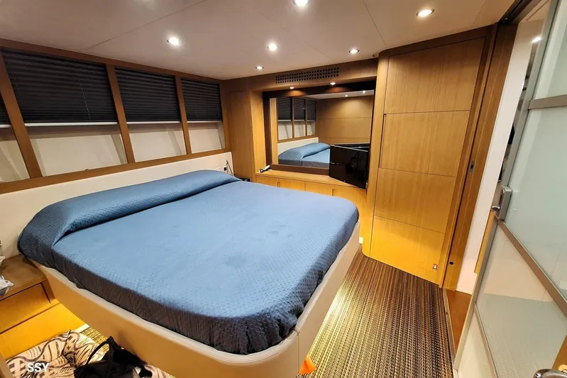 Domale Yacht Photos Pics Luxurious bedroom interior of 2009 Pershing 56 yacht with modern design and blue bedding.