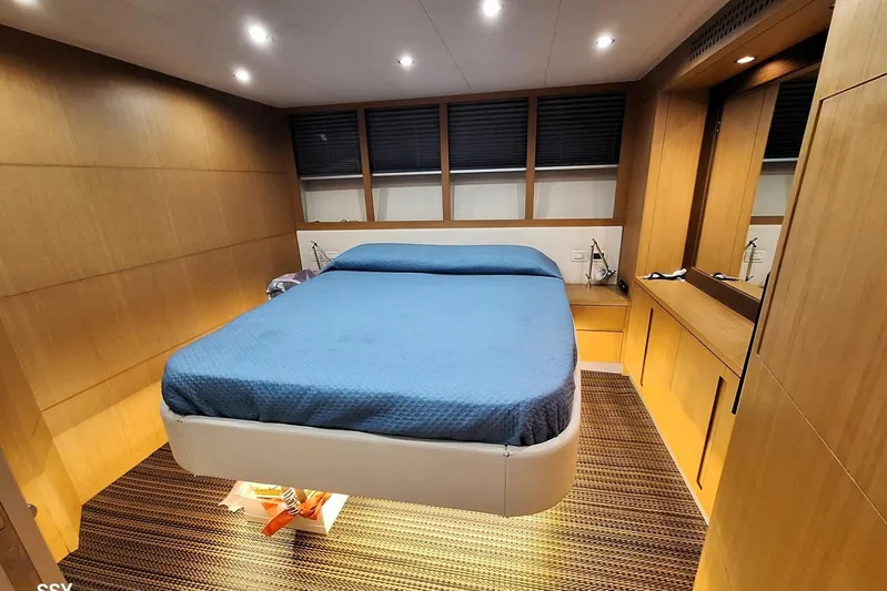 Domale Yacht Photos Pics Luxurious bedroom interior of 2009 Pershing 56 yacht with modern wood paneling.