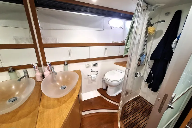 Domale Yacht Photos Pics Luxurious bathroom in 2009 Pershing 56 yacht with modern fixtures and elegant design.