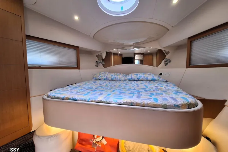 Domale Yacht Photos Pics Luxurious bedroom interior of 2009 Pershing 56 yacht with modern design and cozy bedding.