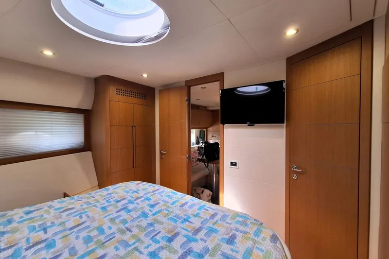 Domale Yacht Photos Pics Luxurious 2009 Pershing 56 yacht interior with modern wood paneling and cozy bedding.