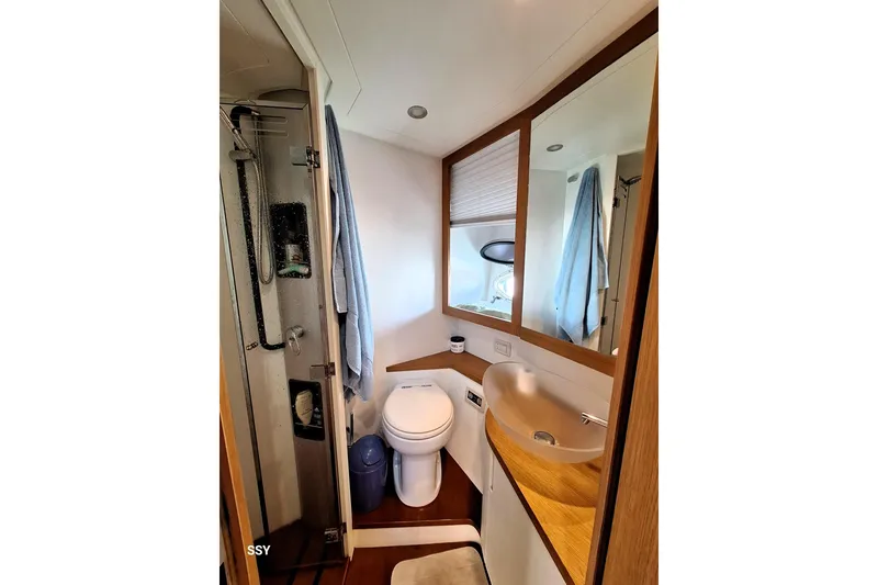 Domale Yacht Photos Pics Luxurious bathroom in 2009 Pershing 56 yacht with modern fixtures and elegant design.