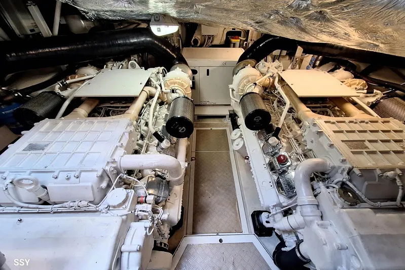Domale Yacht Photos Pics Engine room of a 2009 Pershing 56 yacht, showcasing dual engines and mechanical components.