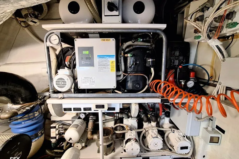 Domale Yacht Photos Pics Engine room of a 2009 Pershing 56 yacht, showcasing complex machinery and wiring.