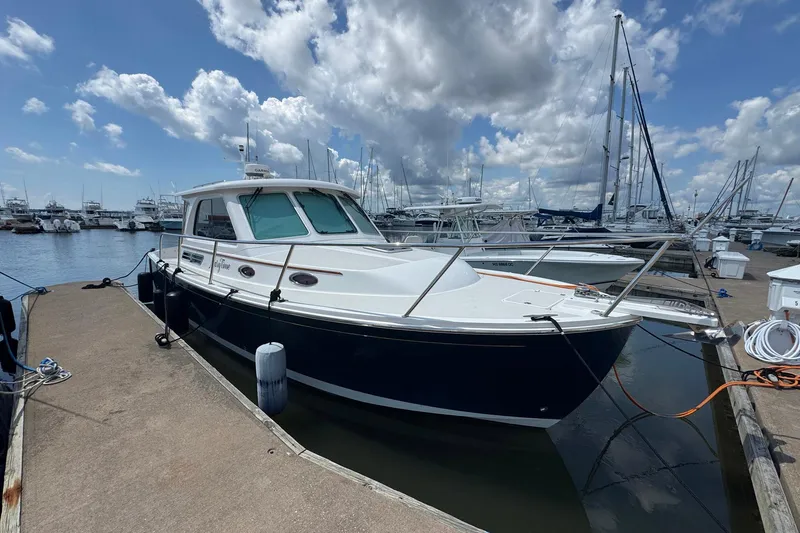 Mary Time Yacht Photos Pics 2013 Back Cove 30 boat docked at marina under cloudy sky.