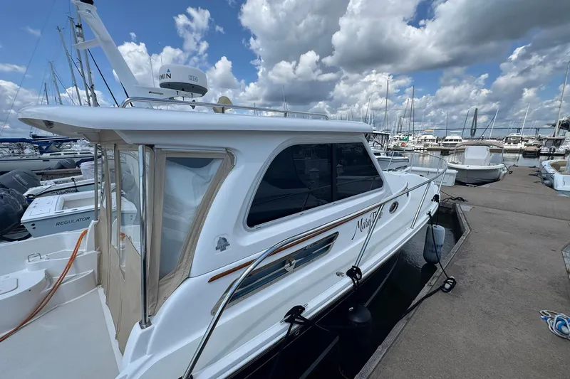 Mary Time Yacht Photos Pics 2013 Back Cove 30 boat docked at marina under cloudy sky.