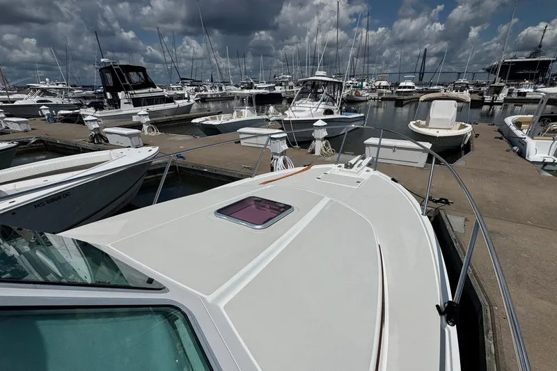 Mary Time Yacht Photos Pics 2013 Back Cove 30 boat docked at a marina under a cloudy sky.
