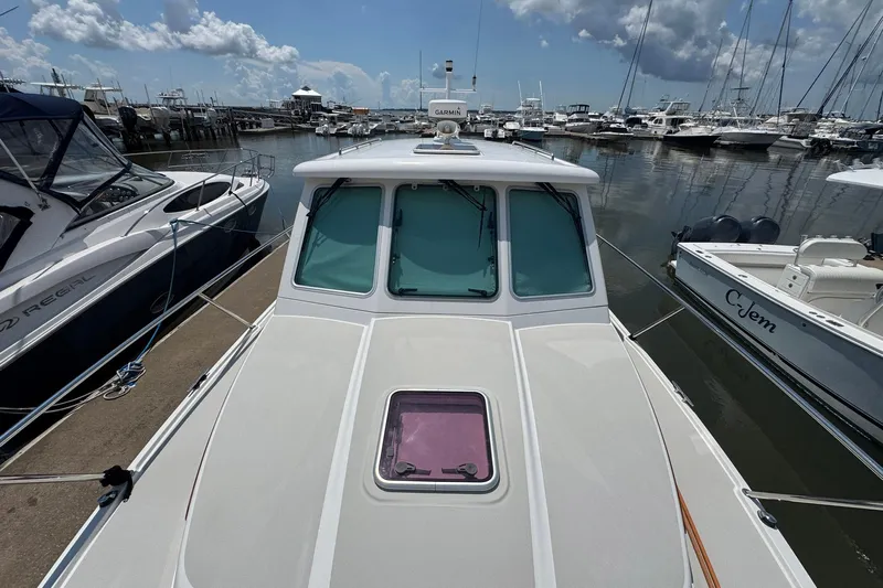 Mary Time Yacht Photos Pics 2013 Back Cove 30 boat docked at marina, surrounded by other vessels under a cloudy sky.