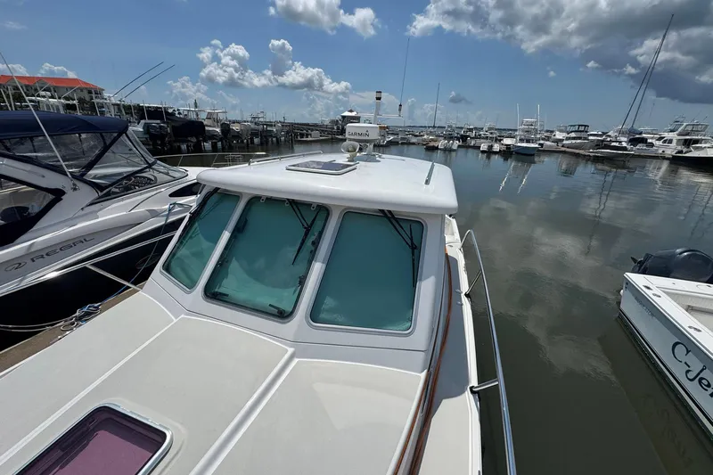 Mary Time Yacht Photos Pics 2013 Back Cove 30 boat docked in a marina under a partly cloudy sky.