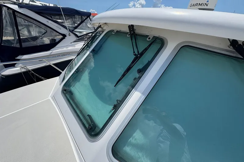 Mary Time Yacht Photos Pics 2013 Back Cove 30 boat windshield with wipers, docked alongside other vessels.