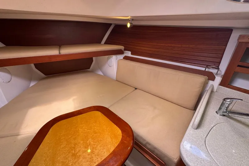 Mary Time Yacht Photos Pics 2013 Back Cove 30 interior cabin with beige seating and wooden accents.