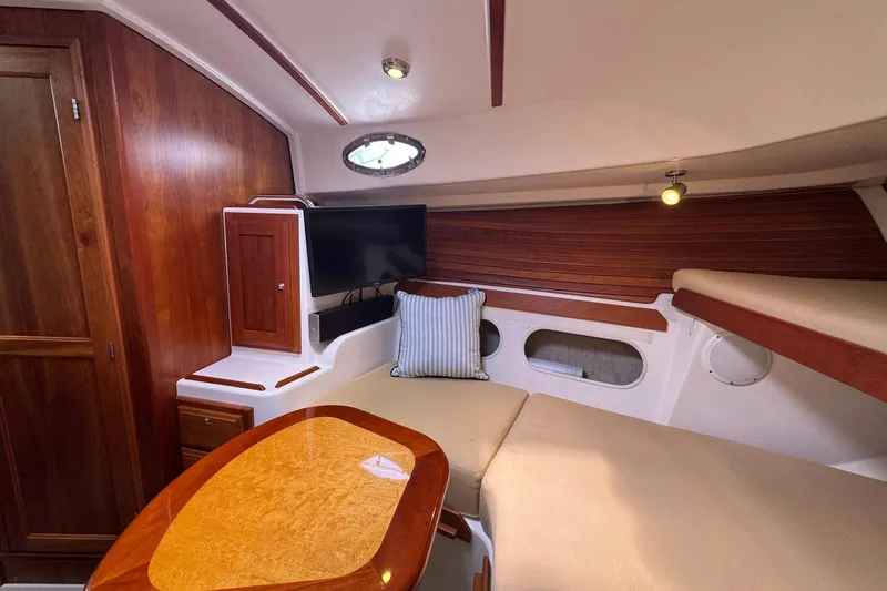 Mary Time Yacht Photos Pics Cozy interior of 2013 Back Cove 30 boat with wood accents and seating area.